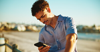 Buy stock photo Relax, typing and man with phone by beach on holiday, vacation and weekend on mobile app in nature. Travel, notification and person by seaside on smartphone for social media, online chat and website