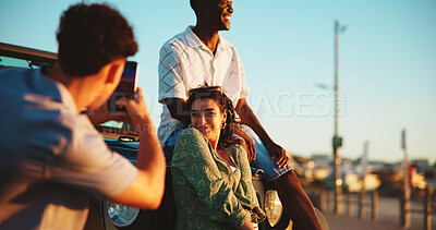 Buy stock photo Phone, photography and friends on road trip with smile, holiday and outdoor bonding together. Fun, digital picture and people on car with smartphone, travel adventure and happy memory on vacation