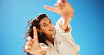 Finger frame, blue sky and portrait of woman for social media post, profile picture or blog. Tongue out, smile and face of female person from Colombia with photography gesture outdoor from below.