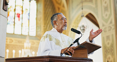 Buy stock photo Worship, pastor and praying in church, faith and preaching with microphone for Christianity or gospel. Podium, preacher and mature man with speech for religion, Easter service or sermon to praise God