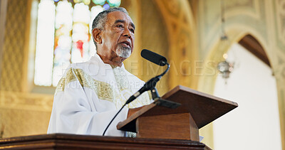 Buy stock photo Christianity, pastor and preaching in church, religion and praying with microphone for faith or gospel. Podium, preacher and mature man with speech for Easter service, belief or sermon to worship God