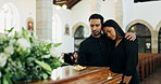 Couple, coffin and hug at funeral in church for death, pay respect or comfort for loss together. Sad man, woman and grief at memorial service with casket for goodbye, mourn or console for depression