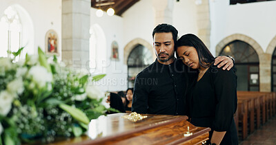 Buy stock photo Couple, coffin and hug at funeral in church for death, pay respect or comfort for loss together. Sad man, woman and grief at memorial service with casket for goodbye, mourn or console for depression