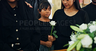 Buy stock photo Loss, death or child with flower in funeral farewell service, mourning person or grief. Coffin, goodbye or girl grieving with sorrow or respect in cathedral for burial, religion and memorial ceremony