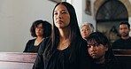 Funeral, family and woman in church, mourning and praying for loss, memorial service and Christianity. Thinking, widow and grieving with child in ceremony, religion and ritual to honor the dead