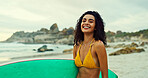 Woman, surfboard and happy in portrait at beach for water sports, hobby and outdoor on holiday. Girl, surfer and smile with equipment for training, fitness and ready for waves by ocean in Costa Rica
