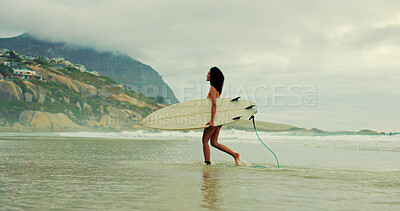 Buy stock photo Girl, surfboard and walk at beach with waves for water sports, hobby and outdoor in morning on holiday. Woman, surfer and happy for training, fitness and start with exercise by ocean in Costa Rica