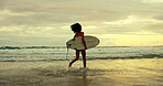 Woman, back and surfboard at beach, running and sunrise with waves, tide and outdoor on holiday. Person, surfer and start with training for water sports, workout and ready for fitness in Brazil