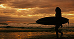 Silhouette, adventure and person with surfboard, beach and journey for surfer on holiday, sunset or sea. Summer vacation, travel and woman with fitness for sport, evening and hobby in nature or ocean