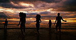 Silhouette, running and friends on beach for sunset, freedom and excited on summer vacation. People, energy and playing at ocean space for travel holiday, adventure and splashing in water for fun
