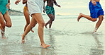 Legs, splash and running with people at beach for playful, summer vacation and adventure. Travel holiday, bonding and freedom with closeup of feet of friends outdoors for social, seaside and care