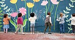 Wall, kids and drawing with chalk for education, cognitive development and creativity in school. Back, students and children with learning for writing mural, inspiration and outdoor in kindergarten