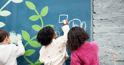 Buy stock photo Wall, students and drawing with chalk for education, cognitive development and creativity in school. Back, group and children with learning for writing mural, inspiration and outdoor in kindergarten