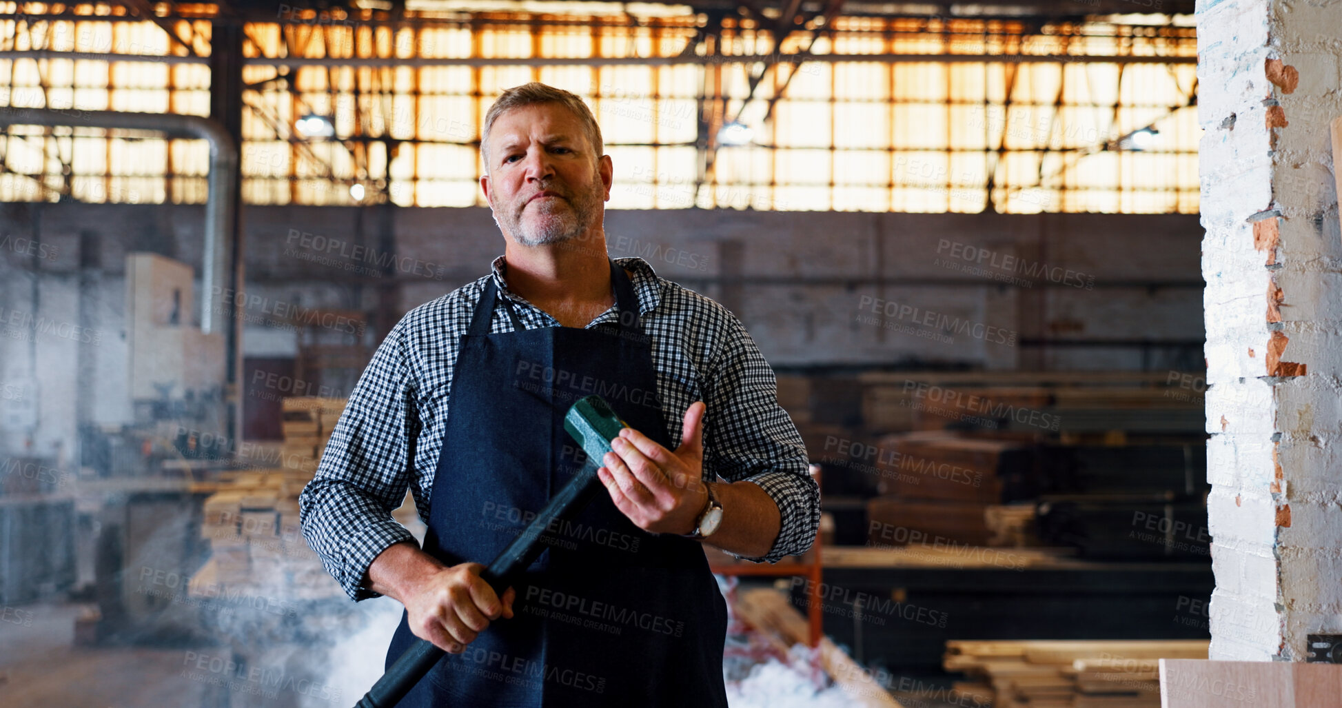Buy stock photo Demolition, hammer and portrait of man in construction industry for building remodel. Contractor, renovation and tool with serious mature person in factory or warehouse for lumber occupation