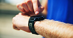 Hands, outdoor and man with fitness, smart watch and track progress with exercise, break and challenge. Person, runner or athlete with training, check cardio or wellness with closeup or monitor heart