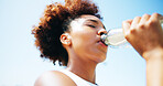 Woman, runner and drinking water with fitness, outdoor and break for hydration, detox and low angle. African girl, bottle and tired with rest in summer for workout, training and electrolytes in Kenya