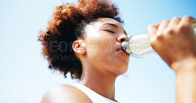 Buy stock photo Woman, runner and drinking water with fitness, outdoor and break for hydration, detox and low angle. African girl, bottle and tired with rest in summer for workout, training and electrolytes in Kenya
