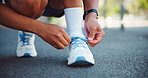 Sneakers, athlete and person with laces in street for fitness, exercise and ready for run outdoor. Cardio, health and wellness with tying shoes for workout, begin training and hands of runner
