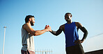 Happy men, fitness and city with handshake for teamwork, meeting or greeting together. Active, male people or friends shaking hands with smile for workout, exercise or training in an urban town