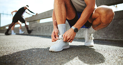 Buy stock photo Fitness, hands and tie shoes on street to start workout, training and exercise for practice on road. City, man and runner tying laces on sneakers for sports, preparation and ready for challenge
