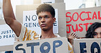 Protest, man and people with poster outdoor for social justice, economic change and stop genocide with solidarity. Group, march and cardboard in city for peaceful rally, human rights and equality