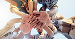 Hands stack, low angle and group of friends outdoor with community, collaboration or support. Circle, bonding and people with palms together for solidarity, goals or target in huddle from below.