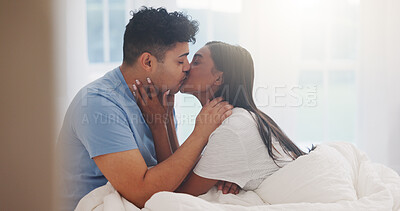 Buy stock photo Couple, kiss and love in bed together, affection and bonding with commitment for trust at home. Romance, partner and security in healthy relationship with intimacy or interracial people in bedroom