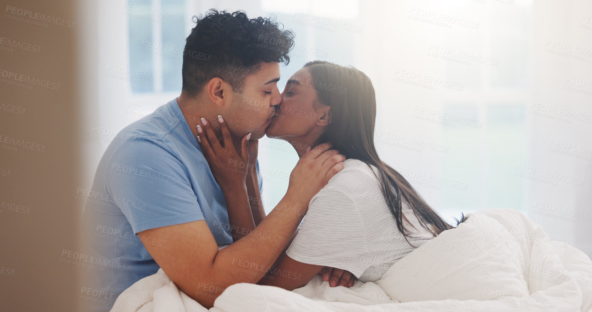 Buy stock photo Couple, kiss and love in bed together, affection and bonding with commitment for trust at home. Romance, partner and security in healthy relationship with intimacy or interracial people in bedroom