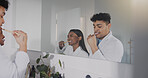 Couple, mirror and brushing teeth together in bathroom for morning routine, oral hygiene and health at home. Man, woman and mouth cleaning in reflection, selfcare and bonding for dental care at house