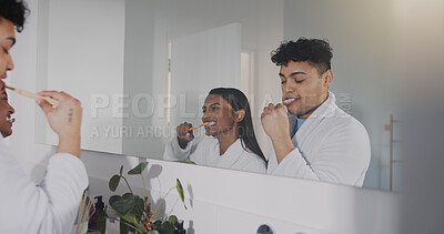 Buy stock photo Couple, mirror and brushing teeth together in bathroom for morning routine, oral hygiene and health at home. Man, woman and mouth cleaning in reflection, selfcare and bonding for dental care at house