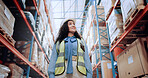 Warehouse, walking and woman in logistics inventory checking boxes, shelf and stock management in distribution. Low angle, smile and plant worker in cargo storage, global export and supply chain