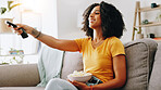 Happy woman, relax and watching tv with popcorn on sofa for online streaming or entertainment at home. Female person, user or remote with smile, snack or bowl for movie, shows or series at house
