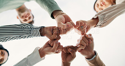 Buy stock photo Fist bump, hands and business people with teamwork, support or collaboration below. Community, group and workers with motivation for cooperation, synergy or closeup for solidarity on white background