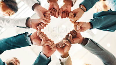 Buy stock photo Fist bump, below and business people in circle for support, mission and team cooperation in huddle. Corporate community, solidarity or synergy with group for partnership, agreement and hands together
