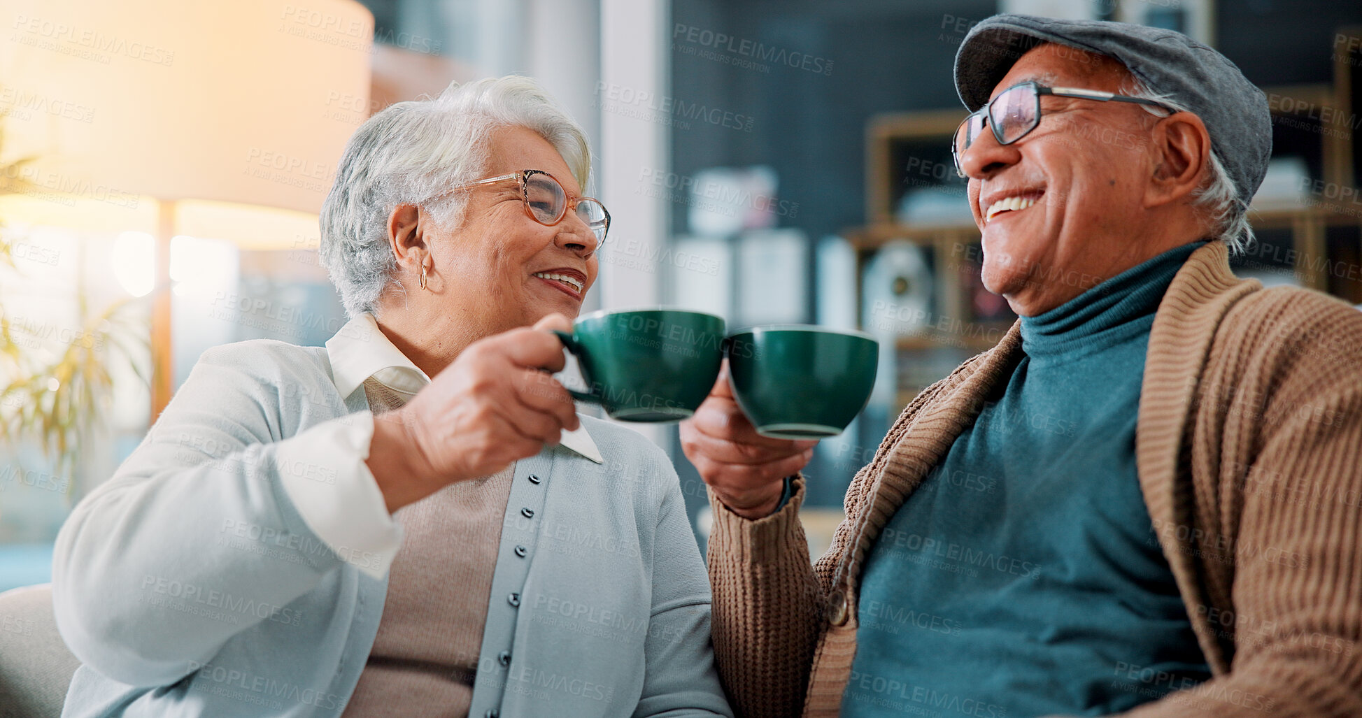 Buy stock photo Senior couple, toast and coffee on sofa with smile, cheers and anniversary with bonding, care and love in home. Elderly woman, man and excited with tea, drinks and happy with celebration in lounge