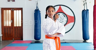 Buy stock photo Karate, portrait and serious with girl student in dojo for combat, martial arts or sports training. Exercise, fitness and workout with confident child in gym for education, development or growth