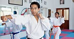 Sensei, punch and man with children in karate class, self defense training or martial arts with youth for combat education. Taekwondo, fight and male instructor with student kids coaching in dojo