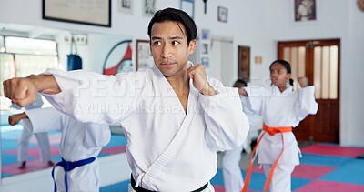 Buy stock photo Sensei, punch and man with children in karate class, self defense training or martial arts with youth for combat education. Taekwondo, fight and male instructor with student kids coaching in dojo