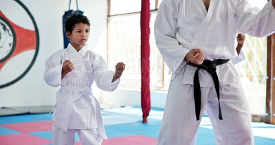 Buy stock photo Boy, lesson and sensei with student in karate class, self defense pose or martial arts with youth for combat education. Taekwondo training, stance and instructor with male child for coaching in dojo