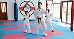 Sensei, lesson and man with children in karate class, self defense training or martial arts for youth for combat education. Taekwondo, smile and male instructor with student kids for coaching in dojo
