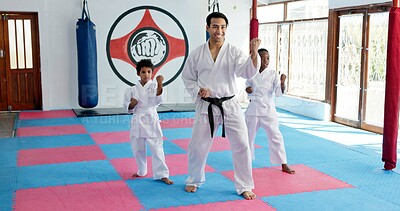 Buy stock photo Sensei, lesson and man with children in karate class, self defense training or martial arts for youth for combat education. Taekwondo, smile and male instructor with student kids for coaching in dojo