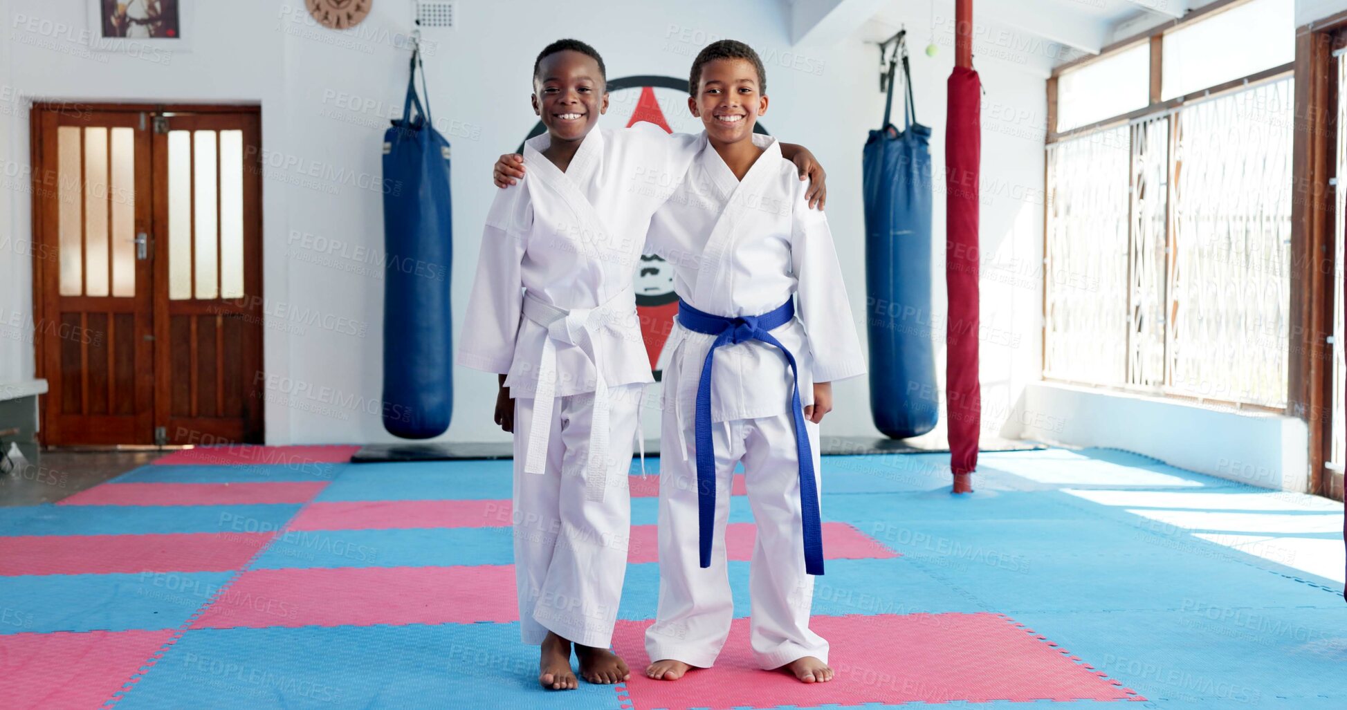 Buy stock photo Hug, karate and portrait of children in dojo for martial arts, self defense or sports training. Development, fitness and smile of student friends embracing in class together for exercise or workout