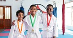 Children, friends and portrait with hug in dojo  for martial arts training, self defense or fighting competition. Boys, prize and medal with support for taekwondo challenge or community karate