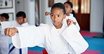 Punch, lesson and girl in karate dojo for self defense training, challenge or skill with martial arts. Children, female student and group for fight, class and taekwondo club with fitness or sports