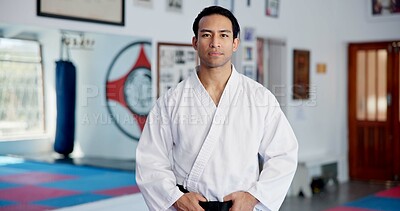 Buy stock photo Dojo, man and fitness in portrait for karate, martial arts practice and discipline for self defense. Indoor, male person and taekwondo with training for combat learning, fighting challenge or uniform