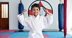 Bicep, karate and portrait of boy student in dojo for combat, martial arts or sports training. Exercise, fitness and flexing muscles with happy child in gym for education, development or growth