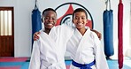 Hug, karate and portrait of friends in dojo for martial arts, self defense or sports training. Development, fitness and smile of student children embracing in class together for exercise or workout