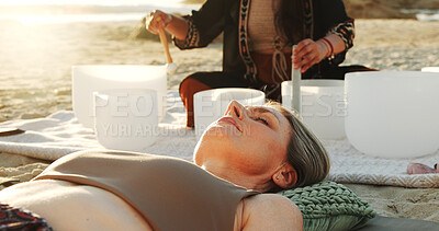 Buy stock photo Meditation, sound therapy and women with bowls at beach for mindfulness, spiritual cleanse and energy. Nature, morning ritual and person with frequency for healing, balance and wellness by ocean