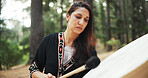 Outdoor, woman and shaman with drum for sound, spiritual healing and traditional performance. Nature, female person and healer with music for holistic therapy, wellness and ritual practice in woods