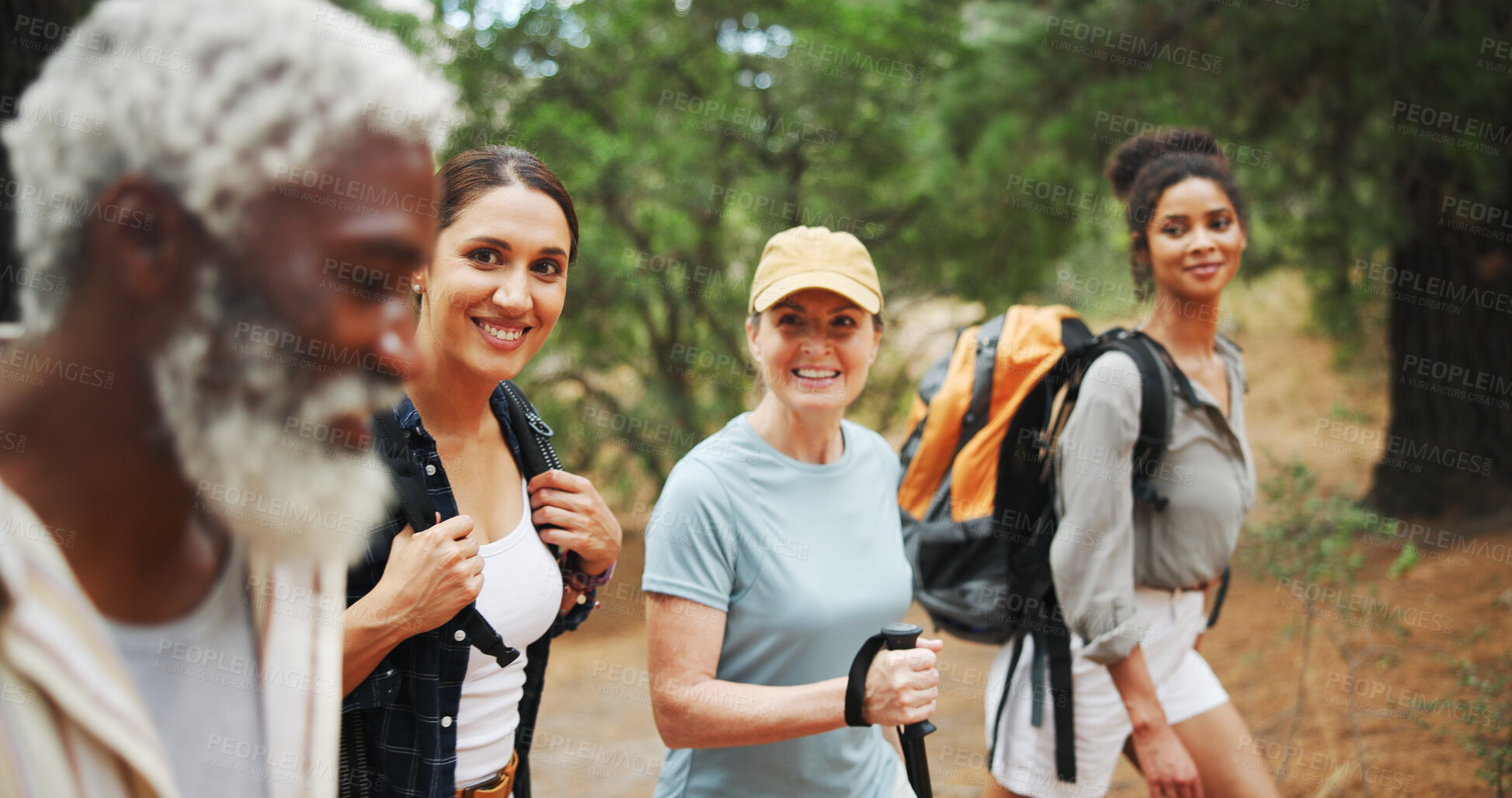 Buy stock photo Fitness, smile and people in nature for hiking, explore environment or journey on trail. Trekking group, man guide and walking in forest for exercise, explain route or outdoor for wellness activity